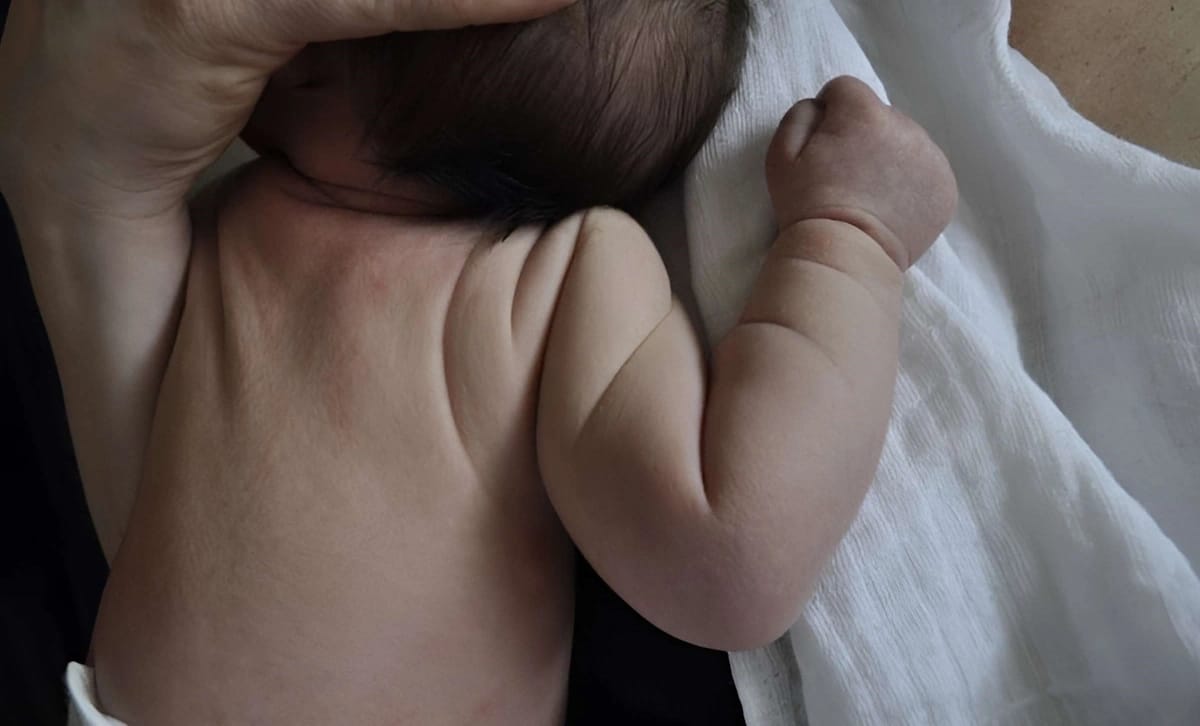 A mother rewarding her baby after successful elimination communication